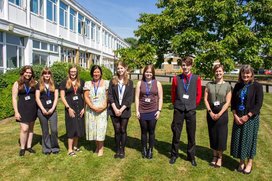 Photograph of students and staff outside the school in the sunshine