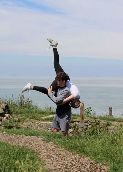 Male and female dance in lift at outdoor location
