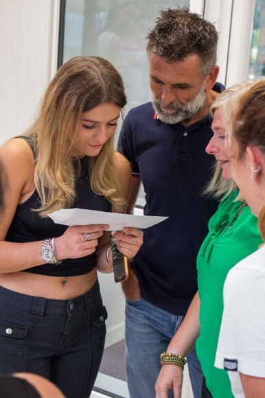 Student opening their results with family members