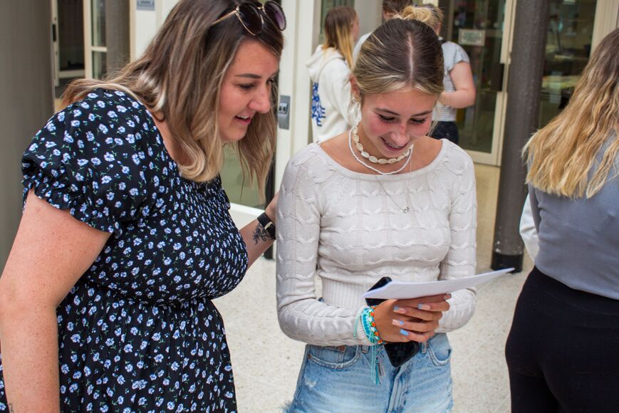 Female student inspects results with Year Manager