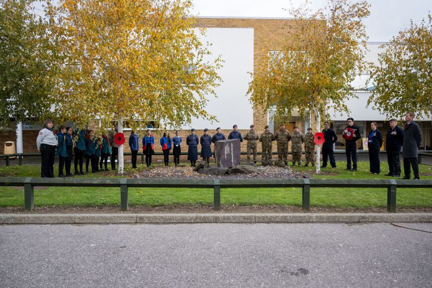 Photo of staff and students assembled in memorial garden for remembrance parade