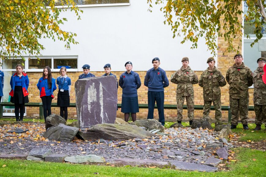 Photo of students in uniform observing two minutes silence
